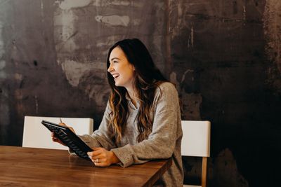 Person holding notebook and pencil smiling