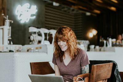 Person smiling at laptop